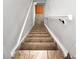 Staircase features plush carpeting, a sturdy white handrail, and tiled landings at the top and bottom at 6336 W 71St Pl, Arvada, CO 80003