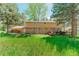 Backyard with lush lawn and a spacious deck perfect for entertaining at 1540 Fawnwood Rd, Monument, CO 80132