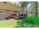 Wood deck features seating/dining areas and yard with green grass at 1540 Fawnwood Rd, Monument, CO 80132