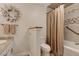 This bathroom features a tub with a shower and tiled walls and floors at 1540 Fawnwood Rd, Monument, CO 80132