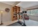 Bedroom with hardwood accent wall, built-in bookshelf, comfortable chair, and large window at 1540 Fawnwood Rd, Monument, CO 80132