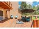 Outdoor deck with seating, dining table, and shade umbrella at 1540 Fawnwood Rd, Monument, CO 80132