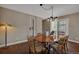 Charming dining room featuring wood flooring, stylish light fixtures, and ample natural light at 1540 Fawnwood Rd, Monument, CO 80132