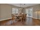 Cozy dining room with hardwood floors, natural lighting and a traditional wooden table set at 1540 Fawnwood Rd, Monument, CO 80132