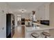 Bright kitchen with stainless steel appliances, tile floors, breakfast bar, and white cabinets at 1540 Fawnwood Rd, Monument, CO 80132