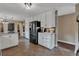 Kitchen with stainless steel refrigerator, white cabinets, and open floorplan at 1540 Fawnwood Rd, Monument, CO 80132