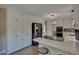Modern kitchen with white cabinetry, stainless steel appliances, and a breakfast bar at 1540 Fawnwood Rd, Monument, CO 80132