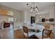 Kitchen area with view to dining area; stainless steel refrigerator, white cabinets at 1540 Fawnwood Rd, Monument, CO 80132