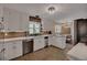 Well-lit kitchen with stainless steel appliances, and white cabinets, and natural wood backsplash at 1540 Fawnwood Rd, Monument, CO 80132