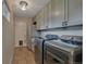 Laundry room with stainless steel washer and dryer and ample storage at 1540 Fawnwood Rd, Monument, CO 80132