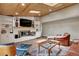 Bright living room with a cozy fireplace, built-in cabinets, and stylish, comfortable furniture at 1540 Fawnwood Rd, Monument, CO 80132