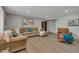 The expansive living room has neutral colors and a large sectional and lots of natural light at 1540 Fawnwood Rd, Monument, CO 80132
