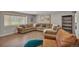 Neutral colored living room with hardwood floors, lots of seating, and natural light at 1540 Fawnwood Rd, Monument, CO 80132