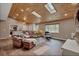Inviting living room with hardwood floors, skylights, and comfortable leather seating at 1540 Fawnwood Rd, Monument, CO 80132