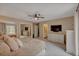 Spacious main bedroom features a ceiling fan, plush carpeting and an ensuite bathroom for convenience at 1540 Fawnwood Rd, Monument, CO 80132