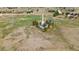 Aerial view of home situated on expansive lot with mature trees, perimeter fence, and neighborhood in distance at 1604 Lisbon Dr, Parker, CO 80138