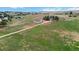 An aerial view showcases the expansive property with its well-maintained lawn and various outbuildings at 1604 Lisbon Dr, Parker, CO 80138