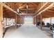 Open barn interior featuring wood beams, a concrete floor, and ample natural light at 1604 Lisbon Dr, Parker, CO 80138