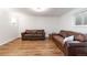 Finished basement with laminate flooring, recessed lighting, and comfortable seating at 1604 Lisbon Dr, Parker, CO 80138
