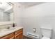 Cozy bathroom featuring a sink, toilet, tiled walls and heater at 1604 Lisbon Dr, Parker, CO 80138