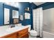 Nicely remodeled bathroom with a new vanity and toilet, complemented by a blue painted wall at 1604 Lisbon Dr, Parker, CO 80138