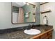 Inviting bathroom featuring a shower, vanity with a dark granite countertop and wooden cabinets at 1604 Lisbon Dr, Parker, CO 80138