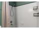 Clean white tiled bath with a shower and neutral accents at 1604 Lisbon Dr, Parker, CO 80138