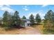Charming two-story home featuring a stone chimney, attached garage and beautiful surrounding trees at 1604 Lisbon Dr, Parker, CO 80138