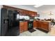 Kitchen features wooden cabinets and black appliances at 1604 Lisbon Dr, Parker, CO 80138
