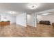 Spacious living room with wood floors, white walls and access to other rooms at 1604 Lisbon Dr, Parker, CO 80138