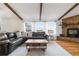 Spacious living room featuring beamed ceilings and a stone fireplace at 1604 Lisbon Dr, Parker, CO 80138