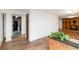 Bright living room featuring wood floors and an accent brick wall with indoor plants at 1604 Lisbon Dr, Parker, CO 80138