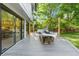 Spacious back deck with a dining table and sliding glass doors leading to the house, perfect for enjoying outdoor meals at 3235 E Easter Pl, Centennial, CO 80122