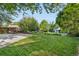 Large backyard features a spacious lawn, mature trees, and patio area for outdoor entertaining at 3235 E Easter Pl, Centennial, CO 80122