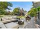 Relaxing backyard patio area with an outdoor sofa, dining table, and serene green space at 3235 E Easter Pl, Centennial, CO 80122
