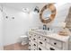 Bathroom featuring a vessel sink on vanity, shiplap accent wall, wood mirror, and modern fixtures at 3235 E Easter Pl, Centennial, CO 80122