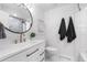 Updated bathroom with stylish mirror, white vanity, and modern fixtures at 3235 E Easter Pl, Centennial, CO 80122