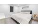 Bright bedroom featuring a large bed, stylish decor, neutral color palette and window at 3235 E Easter Pl, Centennial, CO 80122