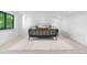 Modern bedroom featuring white walls, carpet flooring, and a large window with natural light at 3235 E Easter Pl, Centennial, CO 80122