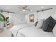 Comfortable bedroom featuring a plush bed, stylish sliding barn doors, and soft neutral colors at 3235 E Easter Pl, Centennial, CO 80122