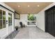 Inviting covered entry featuring a gray-tiled floor, wooden ceiling, and stylish black accents, offering a welcoming entrance at 3235 E Easter Pl, Centennial, CO 80122