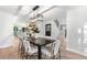 Elegant dining room with a large dark wood table and chairs, open to the modern kitchen and staircase at 3235 E Easter Pl, Centennial, CO 80122