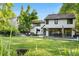 Beautiful home with a well-maintained lawn, outdoor seating, mature trees, and inviting backyard at 3235 E Easter Pl, Centennial, CO 80122