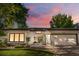 Charming home featuring a well-manicured lawn, an inviting entrance, and a two-car garage, all under a beautiful sunset sky at 3235 E Easter Pl, Centennial, CO 80122