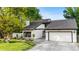 Well-maintained home featuring a lush lawn, a two-car garage, and a welcoming entrance, perfect for suburban living at 3235 E Easter Pl, Centennial, CO 80122