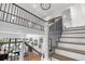 Open foyer showcasing staircase and view of the living room with fireplace at 3235 E Easter Pl, Centennial, CO 80122