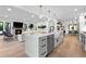 Open-concept kitchen and living area with large island, stainless steel appliances, and fireplace at 3235 E Easter Pl, Centennial, CO 80122