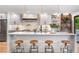 Bright and airy kitchen with a white island, modern pendant lighting, and sleek appliances, perfect for culinary enthusiasts at 3235 E Easter Pl, Centennial, CO 80122