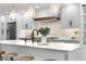 Close up of kitchen featuring a spacious island with marble countertops and modern lighting fixtures at 3235 E Easter Pl, Centennial, CO 80122