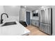 Convenient kitchenette area with stainless steel appliances, ample counter space, and modern finishes at 3235 E Easter Pl, Centennial, CO 80122